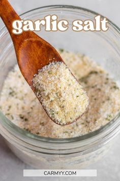 garlic salt in a glass jar with a wooden spoon on the side and text overlay that reads garlic salt