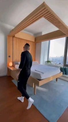 a man is walking in front of a bed