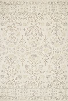 an area rug with leaves and flowers on the side, in neutrals and browns