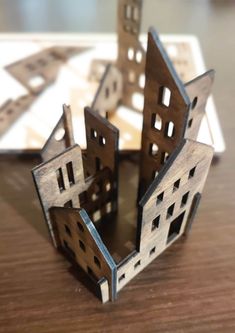 a wooden model of a house on top of a table