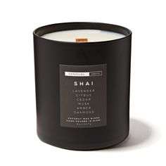 a black candle with the label shai on it's front and back side