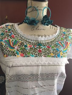 Gorgeous hand embroidered Mexican blouse is comfortable, fresh and stylish With beautiful Paloma embroidery detailed work on the top Get the boho style you like Perfect to wear with your favorite jeans Perfect for summer season! You will love your unique one of a kind piece Is a MUST HAVE in you wardrobe Every blouse is individually handcrafted Color may vary on stitching as each blouse is unique Perfect for any occasion Perfect gift idea *accessories sold separately* **HAND WASH ONLY** Follow u Folk Peasant Top With Multicolor Embroidered Neckline, Traditional White Peasant Top With Geometric Embroidery, Peasant Top With Multicolor Floral Embroidery, White Peasant Embroidered Top With Embroidered Border, Peasant Top With Multicolor Embroidery, Multicolor Embroidered Folk Top With Embroidered Border, Traditional Short Sleeve Embroidered Top With Tonal Embroidery, Traditional Peasant Top With Embroidered Hem For Festival, Traditional White Peasant Top With Intricate Embroidery