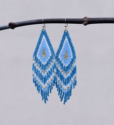 "These handmade earrings are made of high-quality Japanese and Czech beads and strong synthetic thread. They are elegant, fashionable, and suitable for any occasions.  Colors: turquoise, blue , white , grey Length: 4.2 inches (10.8 cm) Width: 0.1 inches (2.7 cm) Materials:     Japanese Miyuki seed beads      Czech \"Preciosa\" beads     Durable synthetic thread     925 Sterling silver ear hooks  Please note Real colour may slightly differ from one monitor to another, as it depends on specific mo Handmade Light Blue Dangle Jewelry, Blue Tassel Drop Earrings For Festival, Handmade Light Blue Earrings For Beach, Handmade Light Blue Beach Earrings, Handmade Turquoise Tassel Earrings, Blue Tassel Earrings With Dangling Beads As Gift, Handmade Light Blue Dangle Earrings, Light Blue Earrings With Dangling Beads As Gift, Light Blue Earrings With Dangling Beads For Gift