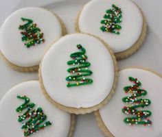 decorated cookies on a white plate with green and red decorations