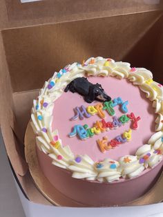 a birthday cake in a box with the words happy birthday written on it