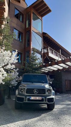 a mercedes benz is parked in front of a building