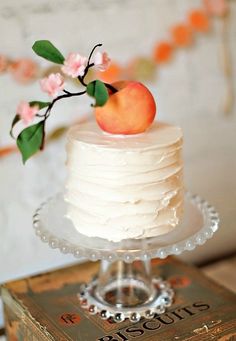 a small white cake with an apple on top