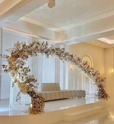 an elegant wedding setup with white flowers and greenery on the wall, in front of a large mirror