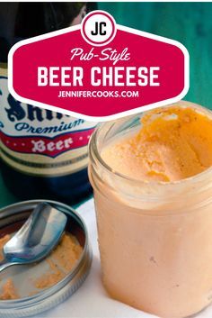 a jar of beer cheese next to a spoon