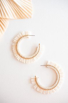 The Gracie Rattan Fan Hoops are the perfect accessory to elevate your tropical vacation style. These colorful rattan hoop earrings exude a playful and vibrant charm that complements any summertime outfit. Handcrafted with intricate attention to detail, each earring features a unique fan-shaped design, adding a touch of whimsy and exotic flair. Made from sustainable rattan material, these lightweight hoops provide a comfortable fit without compromising on style. Whether you're strolling along the Adjustable Small Hoop Earrings For Vacation, Small Hoop Earrings For Vacation, White Small Hoop Earrings For Beach, White Hoop Earrings For Vacation, White Beaded Hoop Earrings For Beach, Summer Vacation Hoop Earrings, Chic Woven Earrings For Vacation, Beach Dangle Hoop Earrings, Summer Beach Multicolor Hoop Earrings