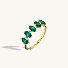 The 5 Stone Emerald Ring will demonstrate your taste with its elegancy so that you can feel yourself more stylish and special at any time of the day with the 5 Stone Emerald Ring, which will gather all the attentions around you with its sparkly emerald coloured stones, and you can make your special moments even more special. - Made in 14k solid gold - Decorated with handset emerald coloured cubic zirconia stone on 14k solid gold - Band Width: 1.45 mm / 0.057 inches- Ring Width: 18.95x6.19 mm / 0 Gemstone Jewellery Design, Dainty Band, Gemstone Collection, Luxury Jewelry Brands, Time Of The Day, Solid Gold Band, Full Eternity Ring, Name Rings, Linking Rings