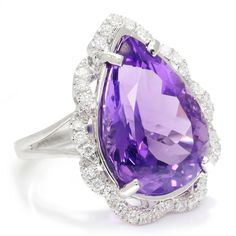 Description: The amethyst has long been thought to symbolize peace, balance and inner strength. This bold and exquisite example of this gem weighs 9.16-carats, is teardrop in shape and sleeps in a bed of diamonds. The pear mixed cut is a treasure chest of facets that exhibit varying shades of light to dark violet hues which are enhanced by the sparkle and fire of the accent diamonds. The solid 18kt white gold ring setting is a perfect celebration piece for this gem. It is a size 6.75 and is Bran Luxury Teardrop Gemstones, Luxury Purple Teardrop Jewelry, Luxury Purple Drop Jewelry, Elegant Teardrop Amethyst Ring For Formal Occasions, Elegant Teardrop Purple Amethyst Ring, Formal Teardrop Amethyst Ring, Elegant Purple Teardrop Amethyst Ring, Purple Amethyst Teardrop Ring, Elegant Purple Teardrop Gemstone