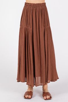 Introducing the Wagon Wheel Piping Tiered Detail Midi Skirt, a perfect blend of classic charm and modern style. Crafted from a soft and breathable blend of 80% rayon and 20% nylon, with a comfortable 100% rayon lining, this skirt is designed for easy, all-day wear with a sophisticated touch. The piping detail adds a subtle yet striking accent that defines the tiers, creating a beautifully layered effect that gives the skirt movement and flow with every step. The tiered design brings a playful, feminine vibe while the midi length offers versatility, making it easy to dress up or down for any occasion. With its flattering fit and boho-inspired look, the Wagon Wheel Midi Skirt pairs effortlessly with blouses, sweaters, or tucked-in tees, making it a staple for both casual days and dressier ev Modest Tiered Skirt, Tiered Rayon Skirt With Elastic Waistband, Modest Tiered Lined Skirt, Flared Rayon Maxi Skirt With Lining, Rayon Skirt With Elastic Waistband, Relaxed Fit Rayon Tiered Skirt, Solid Color Midi Skirt For Beach, Modest Cotton Lined Skirt, Solid Color Rayon Maxi Skirt With Lining