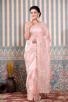 Beautiful light pink embroidered organza saree is a perfect drape for festive occasions! It comes with a matching blouse piece. Disclaimer: The actual product may vary slightly from the image. These are custom orders, hence expect slight variation in color, placement of the motif or buta. ESTIMATED DELIVERYBecause this is a custom order, it would take about 4 weeks from the date of purchase. RETURN POLICYThis product is a custom order and cannot be returned or exchanged. Pink Tissue Silk Pre-draped Saree In Traditional Drape, Pink Tissue Silk Pre-draped Saree, Pink Tissue Silk Pre-draped Saree In Traditional Style, Pink Chanderi Pre-draped Saree With Sheer Dupatta, Pink Chanderi Pre-draped Saree For Reception, Designer Wear Pink Organza Pre-draped Saree, Designer Pink Organza Pre-draped Saree, Pink Tissue Silk Pre-draped Saree For Reception, Pink Organza Pre-draped Saree For Designer Wear