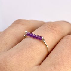 This beautifully simple ring is lovingly handmade with 5 tiny Amethyst gemstones and a choice of 14k Gold Filled, 14k Rose Gold Filled or Sterling Silver band. M A T E R I A L S: * Amethyst * 14k Gold Filled, 14k Rose Gold Filled or Sterling Silver S I Z E: *  Gemstone - Approximately 2mm each *  Band Thickness - Approximately 0.8-1mm  All of our jewellery is carefully handmade using good quality materials and handpicked gemstones, with the aim to produce quality pieces that you can love & wear White Jewelry Box, Wire Jewelry Designs, Bar Ring, Simple Ring, Sterling Silver Wire Wrap, February Birthstone, February Birth Stone, Rings Simple, Sterling Silver Bands