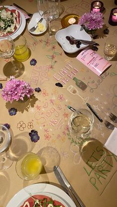 a table topped with plates and glasses filled with food