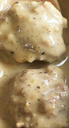 two meatballs covered with gravy in a sauce