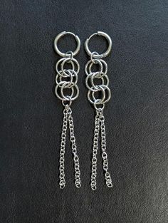 The Waterfall chainmaille earrings consist of huggie hoops with 3 pairs of hoops cascading down to 2 dangling chains. These earrings are approximately 4" long and do have some weight to them but fine for someone used to a substantial earring. Sold as a pair  All stainless steel Cheap Silver Spiral Earrings, Edgy Nickel-free Dangle Earrings, Chain Mail Earrings Lone Rock Jewelry, Chainmail Patterns Earrings, Edgy Nickel-free Dangle Plug Earrings, Unique Nickel-free Dangle Chandelier Earrings, Gothic Metal Dangle Plug Earrings, Black Nickel-free Dangle Chandelier Earrings, Earrings Goth