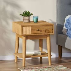 a small wooden table with a plant on it