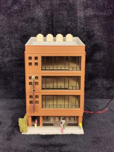 a toy model of a building on a black background