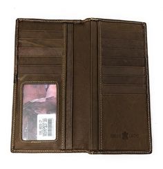 Montana West brand western style men's bi-fold wallet, made of hand tooled genuine leather. Features: Genuine leather exterior, leather and fabric lining Leather applique on the front with floral tooling and an antique silver floral concho 13 credit card slots, 1 ID widows, 3 bill compartments, 1 additional slot on the back Size: 7 1⁄2" x 3 1⁄2" x 1⁄2" Color: Coffee Rustic Brown Bifold Wallet, Rectangular Leather Wallet With Hand Tooling, Western Style Leather Rectangular Wallet, Western Style Brown Leather Wallet, Western Style Brown Trifold Wallet With Card Slots, Bifold Wallet Men, Western Leather Wallets With Card Slots, Western Leather Wallet With Card Slots, Artisan Hand-tooled Leather Trifold Wallet