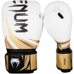 a pair of white and gold boxing gloves with black lettering on the front, one is worn