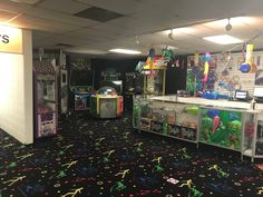 the inside of a toy store with arcade machines