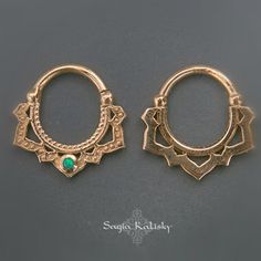 two pairs of gold hoop earrings with green stones in the center and an intricate design on each side