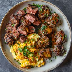 a white plate topped with meat and potatoes