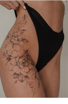 a woman's thigh with flowers on it