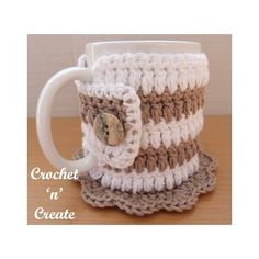 a crocheted coffee cup with a button on it