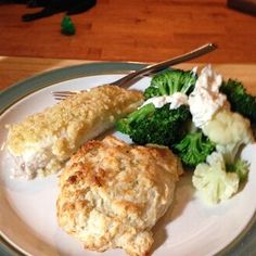 a white plate topped with chicken, broccoli and mashed cauliflower