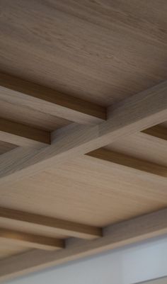 the underside of a wooden ceiling with beams