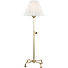 an antique brass floor lamp with a white shade on the base and a gold finish