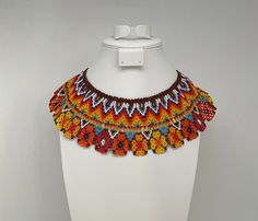 This beautiful beaded necklace is hand-woven by the women of the Embera Chami Indigenous Tribe of Colombia Artisan Beaded Adjustable Bib Necklace, Artisan Beaded Bib Necklace With Adjustable Fit, Southwestern Handwoven Festival Jewelry, Southwestern Handwoven Jewelry For Festivals, Multicolor Southwestern Style Necklaces, Festival Beaded Bib Necklace, Traditional Beaded Necklaces With Bead Caps, Traditional Beaded Necklaces With Round Beads, Multicolor Bead Caps Necklace For Festival