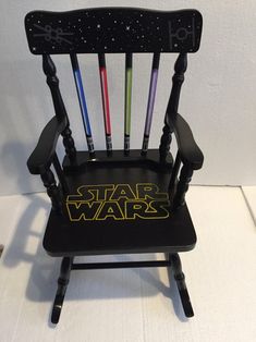 a star wars rocking chair with darth vader and lightsabes on it