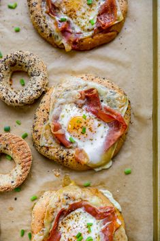 an egg and bacon bagel breakfast sandwich on a baking sheet with pretzels