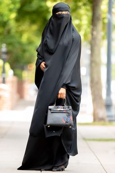 Flex your jilbab style with our Mahasen Jilbab Set in Classic Black. Crafted in luxuriously soft, silk Nida, this 3-piece stunner has an amazingly beautiful flow. The set includes the jilbab, skirt, and niqab with each being able to be worn individually or with other items in your wardrobe. Quietly elegant and superbly modest, our Mahasen Jilbab set will make you feel simply lovely. Made with buttery-soft Korean silk Nida 3-Piece Set includes the Jilbab, Elastic Waist Skirt and Niqab Hijab not i Black Long Sleeve Khimar For Eid, Modest Black Khimar, Black Jilbab, Niqab Hijab, Luxury Black Niqab For Women, Elegant Long Black Niqab, Blue Raincoat, Hijab Niqab, Garment Workers