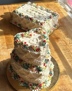 three tiered cake sitting on top of a wooden table