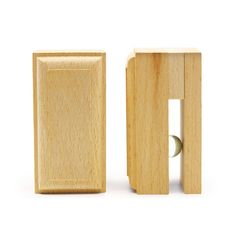 a pair of wooden blocks with one door open and the other half closed, on a white background