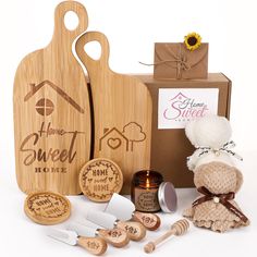 a wooden cutting board and other items are shown in front of a box with the word home sweet written on it