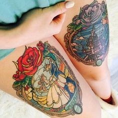 a woman's leg with tattoos on it and an image of beauty and the beast