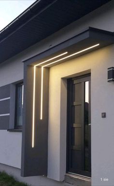 an exterior view of a house with modern lighting