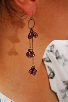 Ascetic long rustic bohemian cascade earrings with dark purple Czech glass beads made of bronze colored metal alloy. Perfectly fit for daily wearing as good as for fun parties with friends and romantic nights with boyfriend. Length of earrings is about 9 cm (3,5 inches) Bohemian Purple Dangle Chandelier Earrings, Bohemian Purple Droplet Chandelier Earrings, Long Drop Brass Chandelier Earrings, Purple Teardrop Chandelier Earrings As Gift, Purple Metal Chandelier Earrings For Gifts, Purple Metal Chandelier Earrings As Gift, Purple Metal Dangle Chandelier Earrings, Purple Metal Chandelier Dangle Earrings, Purple Dangle Brass Earrings