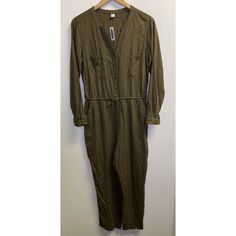 Old Navy Women's Size M Olive Green Viscose Long Sleeve Button Up Cropped Jumpsuit Old Navy Jumpsuit Olive Green 100% Viscose Cropped Long Sleeve Button Up Closure Elastic Waist With Adjustable Drawstring 2 Chest Pockets And 2 Front Side Pockets Women's Size Medium Very Good Preowned Condition With No Rips, Holes Or Stains Noted. Armpit To Armpit: 20" Inseam: 24" Casual Jumpsuits And Rompers With Buttons For Work, Fall Utility Jumpsuits And Rompers With Buttons, Utility Style Jumpsuits And Rompers With Buttons For Fall, Casual Jumpsuits And Rompers With Button Cuffs, Casual Jumpsuits And Rompers With Button Closure For Work, Relaxed Fit Jumpsuits And Rompers With Buttons For Fall, Cotton Jumpsuits And Rompers For Workwear, Spring Long Sleeve Jumpsuits And Rompers With Buttons, Cotton Jumpsuits And Rompers With Buttons For Work