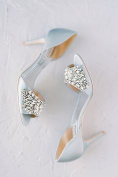 the bride's shoes are adorned with crystal stones