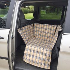 the back end of a van with a plaid seat cover