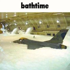 an airplane that is in some kind of building with snow on the ground and it says, bathtime