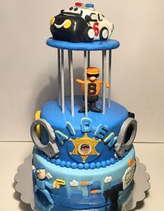 a blue cake with police cars on top