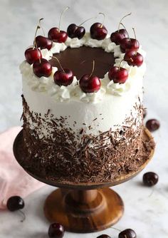 a chocolate cake with cherries on top